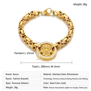 Detail of gold Hamsa hand charm set with white rhinestones on a chunky chain bracelet