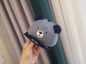 Detail of baby sun hat with navy stripes, 3D bear ears and soft cotton fabric
