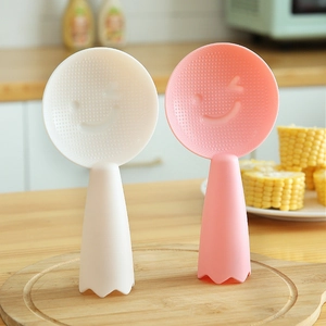 Non-stick standing rice paddles in white and pink with cute smiley face relief design
