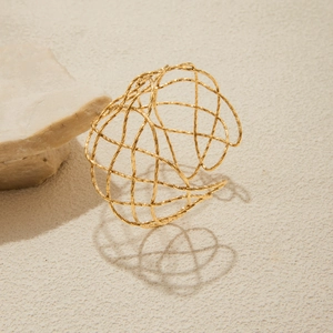 Detailed view of 18K gold hammered texture open cuff with intricate woven hollow patterns