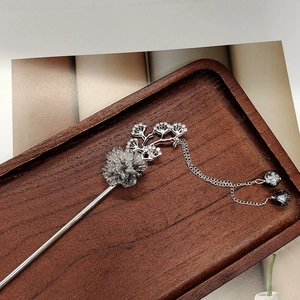 Vintage silver flower hair stick with elegant tassels and beads on wooden tray
