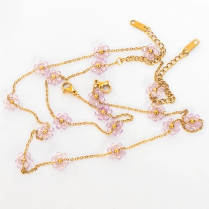 Detail of lobster clasp and stainless steel tag on purple beaded flower necklace