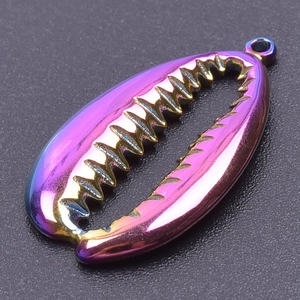Macro shot of rainbow iridescent shell pendant with 18k gold plating on black background