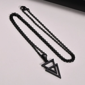 Macro shot of black geometric double-layer triangle pendant on a minimalist chain