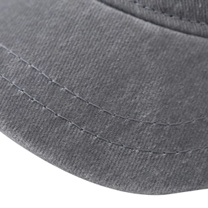 Macro view of double stitching on the short brim of a washed cotton baseball cap