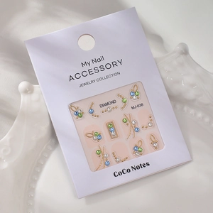 Detailed view of MJ-038 nail art kit with colored rhinestones and gold geometric frames