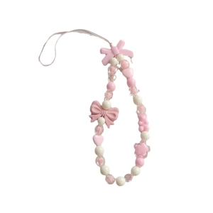 Pink and white beaded phone charm lanyard with acrylic bows and hearts on white background