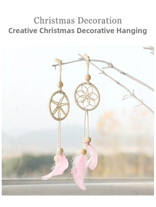 Close-up of Christmas dreamcatcher pendants with wood beads and pink feathers
