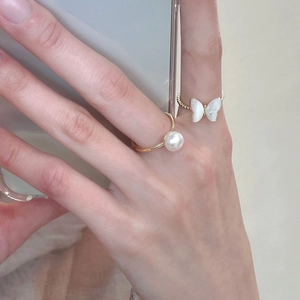 Elegant gold butterfly rings with white pearl and mother of pearl inlay on model
