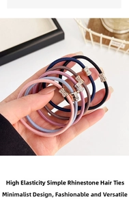 Close-up of five high-elastic hair ties in assorted colors with rhinestone S-shaped accents