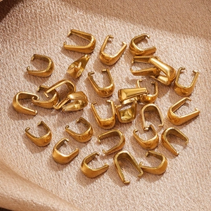 Bulk gold plated stainless steel U-shaped pendant clasps on smooth brown silk fabric