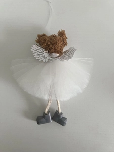 Detail of Christmas angel ornament featuring a white mesh skirt and plush brown head