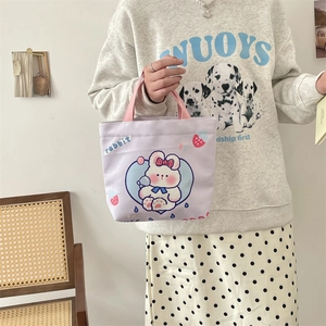 Detail of light purple canvas tote with pink handle and cute cartoon rabbit print