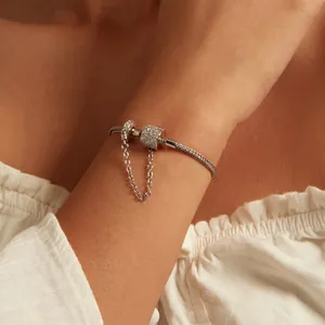 S925 sterling silver snake chain bracelet with sparkling zircon charms on model's wrist
