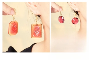 Model wearing glitter resin earrings in rectangle and round shapes with gold hooks