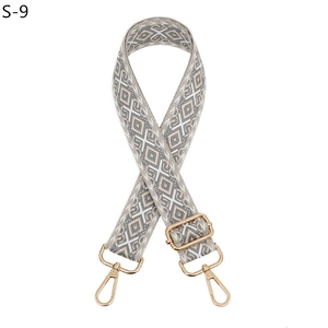 Close-up of adjustable beige geometric diamond pattern strap with gold metal hooks