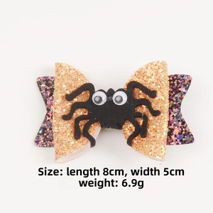Detail view of 8x5cm Halloween bow hair clip featuring glitter fabric and felt spider