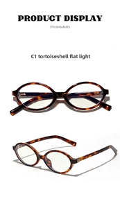 Detail view of oval tortoiseshell frames with golden metallic accents on temple hinges