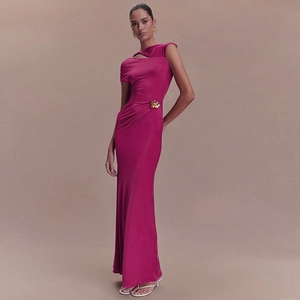 Detail of rose red one-shoulder dress with gold flower buckle and pleated waist texture