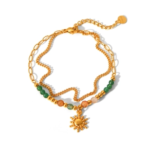Detail of double-layer stainless steel bracelet with colored beads and sun pendant