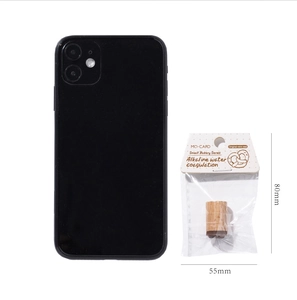 Close-up of beech wood stamps in Bakery Series packaging next to a phone for scale