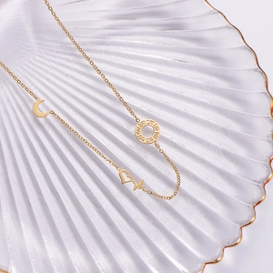 French retro gold necklace with moon, heart and geometric circle pendants on seashell