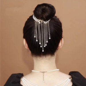 Elegant pearl tassel hair clip worn on a bun hairstyle, golden metal finish headpiece