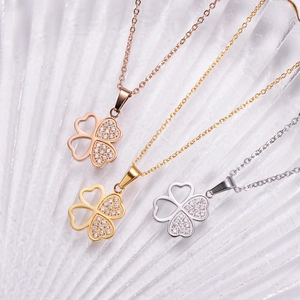 Detailed view of four-leaf clover necklaces in rose gold, gold, and silver with zircons