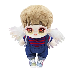Detail view of cotton doll with brown hair, angel wings, striped tee and denim overalls