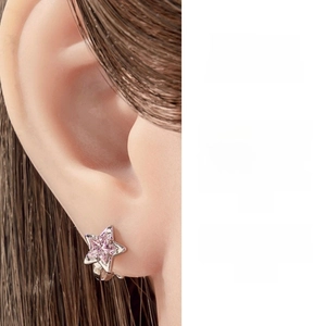Detailed close-up of a silver star hoop earring featuring a pink zircon on the ear