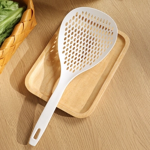 Japanese style white plastic slotted spoon with long handle on wooden tray