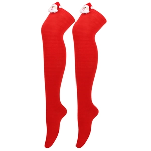 Detail of red striped over-knee Christmas socks with cute 3D Santa Claus doll decorations