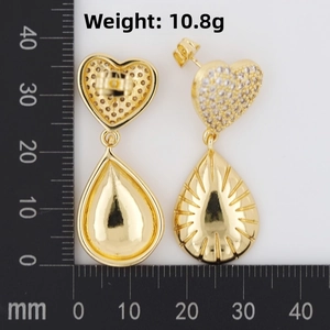 Detailed view of heart and teardrop earrings showing 10.8g weight on a scale
