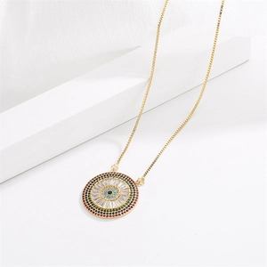 Detailed close-up of a gold evil eye pendant with colorful pavé cubic zirconia