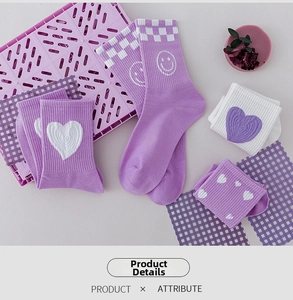 Detail view of purple cotton socks with heart patterns and checkered knit textures
