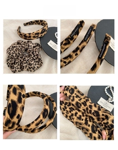 Detail view of retro leopard print headband and scrunchie set with handmade fabric label