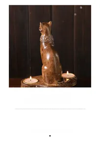 Close-up of Egyptian Bastet cat double candle holder with wood-like texture and relief