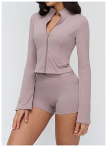 Detail of mauve yoga set featuring zip-up stand collar jacket and high waist shorts