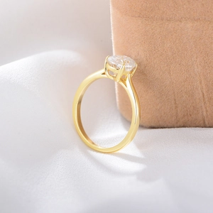 Detail of s925 silver ring with golden finish and round sparkling cubic zirconia stone