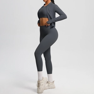 Detail of charcoal grey three-piece yoga set with zip jacket and high waist leggings