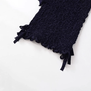 Dark blue textured knit top with detailed bubble fabric and side bow accents