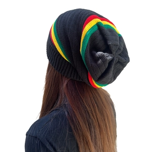 Close-up of Rasta style knitted beanie with red, yellow and green stripes on black wool