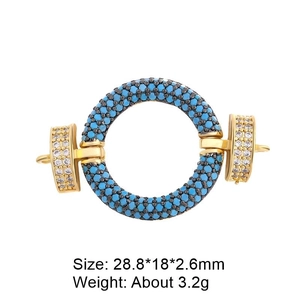 Detailed view of gold connector with blue turquoise stone inlay and side crystal accents