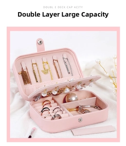 Pink double-layer jewelry box detail showing necklace hooks and ring slots on velvet lining