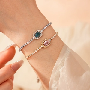 Macro detail of silver and gold adjustable bracelets with blue and pink zircon crystals