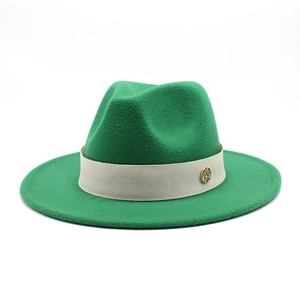 Detail of green wool fedora hat featuring a contrast band and golden metal buckle
