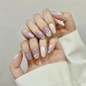 Handmade lavender cat eye press-on nails with white lace patterns and 3D swan charms