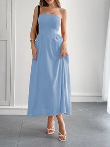 Elegant light blue strapless A-line maxi dress with subtle textured fabric and graceful drape