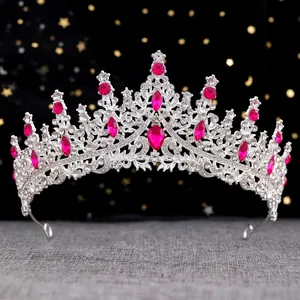Detail of silver crown with ruby red crystals and rhinestone embellishments