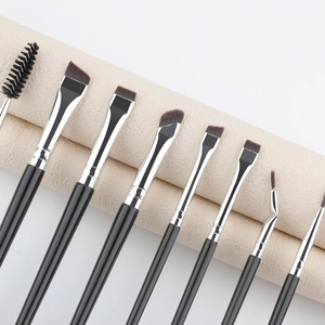 Detailed view of 8 professional eye makeup brushes with black handles and silver ferrules